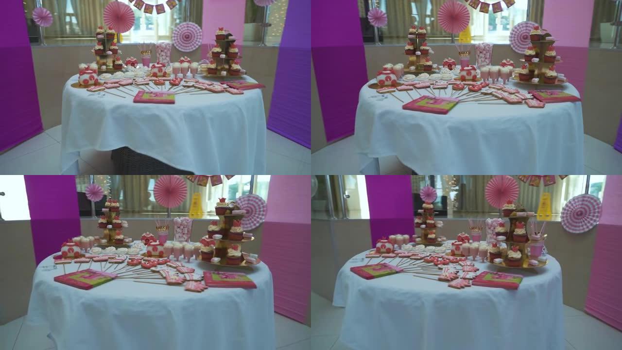 自助餐，提供许多甜食，糖果棒站在白色桌子上，在庆祝活动中等待客人。漂亮的糖果棒，生日蛋糕和糖果