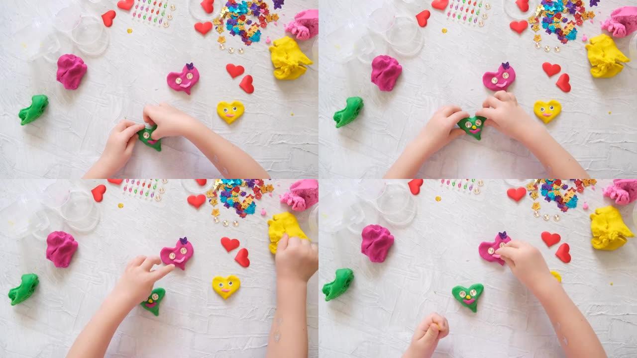 儿童玩彩色模型橡皮泥与珠子和亮片