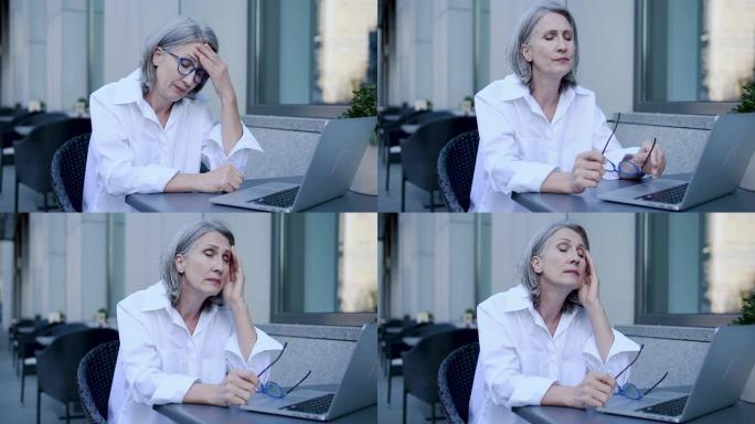 不确定疲惫的女人脱下眼镜感觉乏力工作笔记本电脑