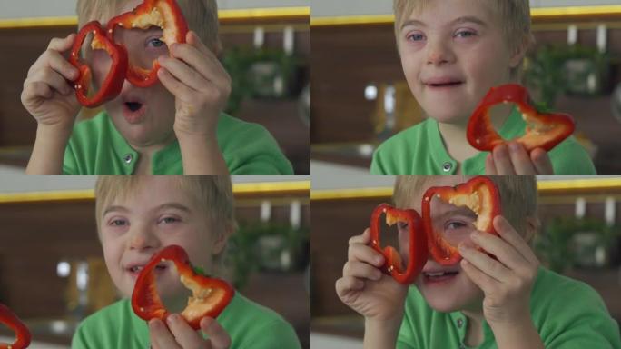 唐氏综合症男孩在厨房里吃蔬菜的特写镜头