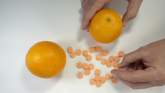 手在4k中摄取维生素和橙色水果