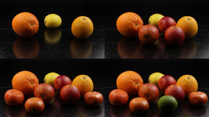 橘子，柠檬，酸橙和橘子被放在黑色的木桌上