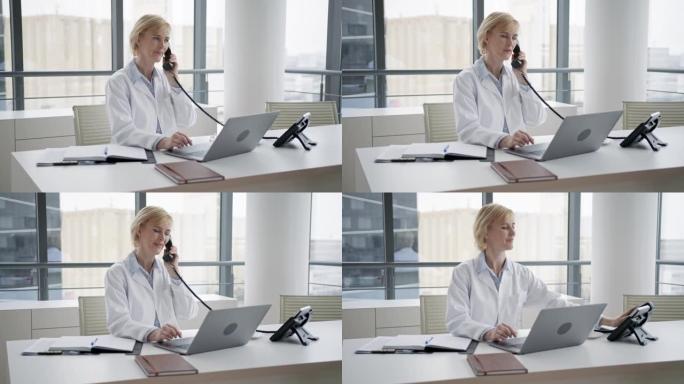 在办公室使用固定电话的女医生