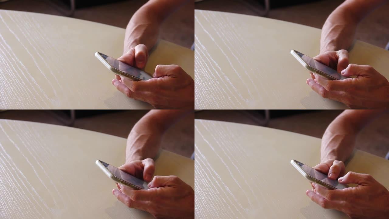 男子将手机放在桌子上和短信上的特写镜头