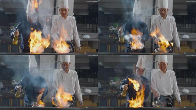 两名厨师在厨房用燃烧的火烹饪食物