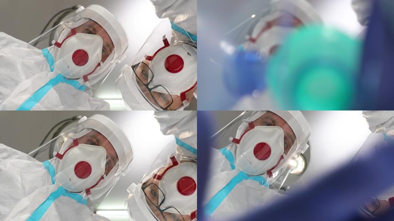 穿着covid安全服的医生戴着口罩给病人戴上氧气面罩进行复苏。病人在床上的POV看到两名医生在急诊室