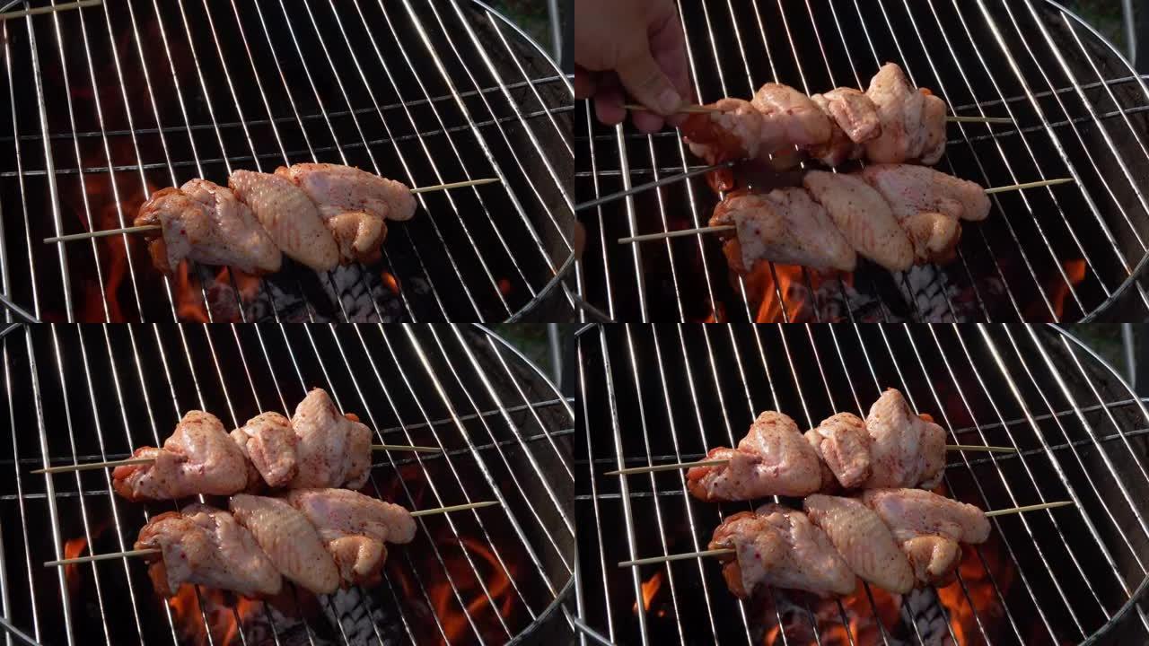 木串上的生鸡翅放在烤架上