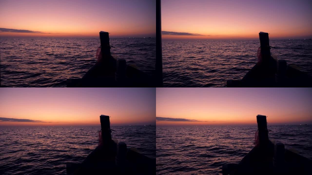 在美丽的日出和五颜六色的天空的海洋中航行，前视图