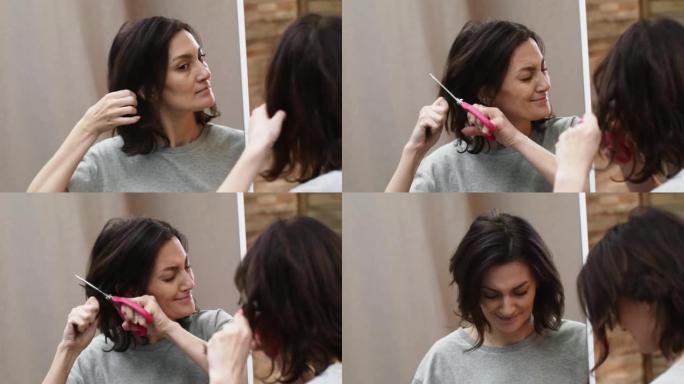 镜子里的女人用剪刀剪了一束头发。这个女人很高兴以一种新的生活方式改变自己的外表