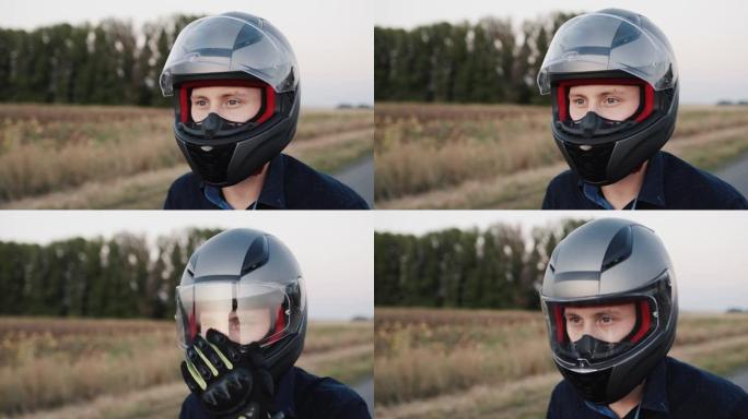一个年轻骑自行车的人的肖像，准备骑摩托车。关闭头盔上的保护玻璃