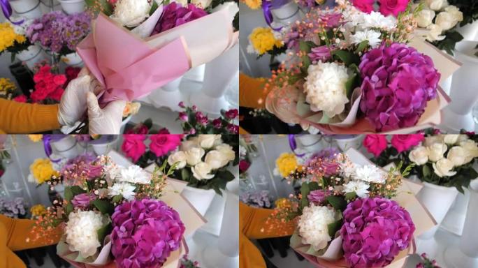 花店在商店里用粉色箔纸包裹美丽的花束