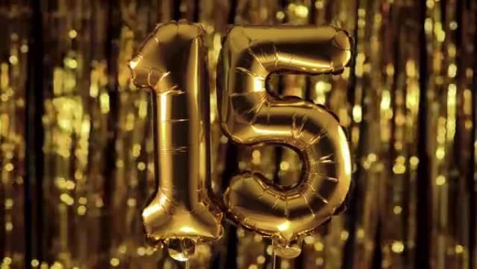 黄色背景上的充气气球上的金色数字15十五。一组完整的数字。生日、周年纪念日、日期的概念
