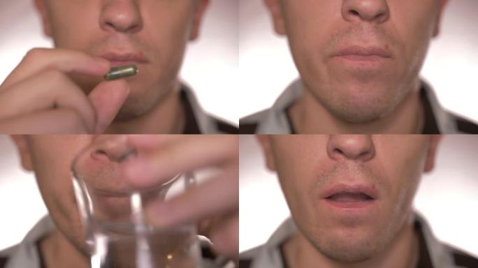 一个人吃着绿色药片，喝着水的特写