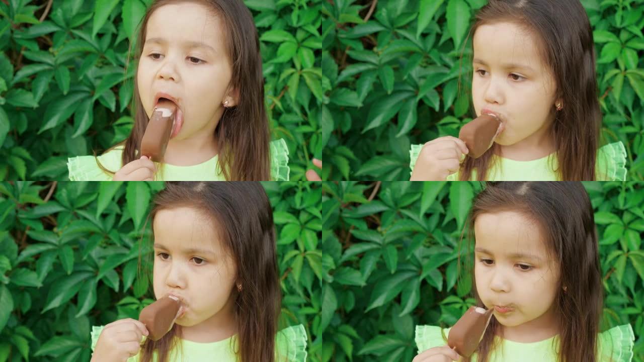 一个穿着鲜绿色连衣裙的可爱又有趣的小女孩做鬼脸，吃冰淇淋。