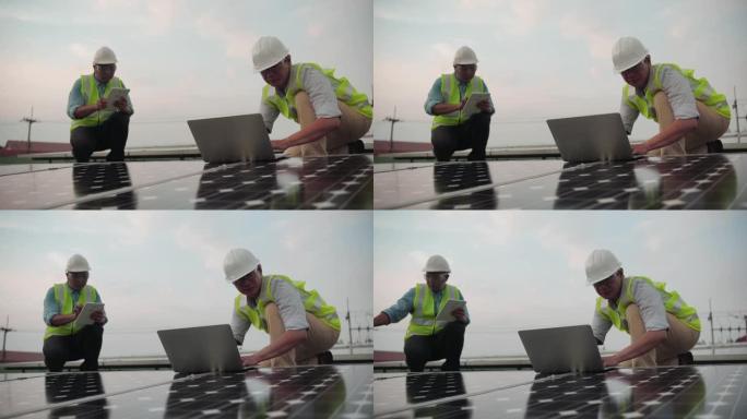 工程师在太阳能农场使用笔记本电脑和项目计划，在太阳能安装时检查面板