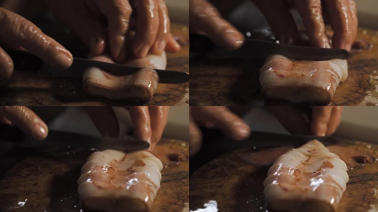 鱿鱼被一位老太太的手刀砍了。下面是圆形木板。宏观拍摄。用传统方式准备海鲜餐。