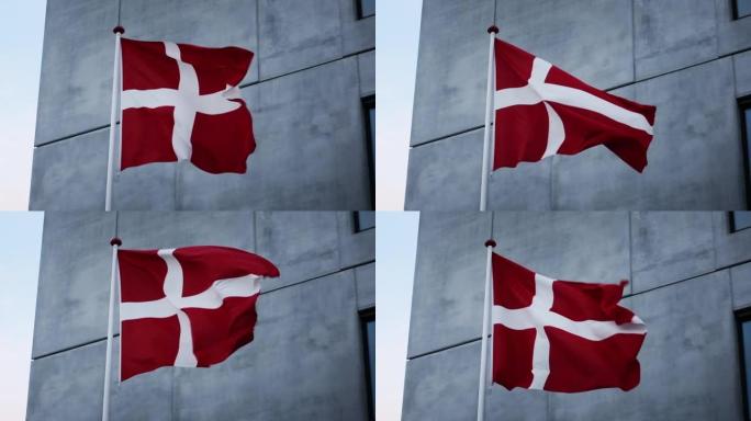 丹麦国旗在灰色建筑外吹拂