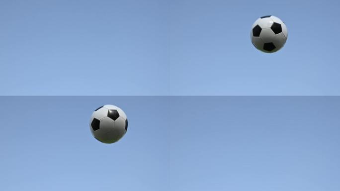 足球足球飞过湛蓝的天空