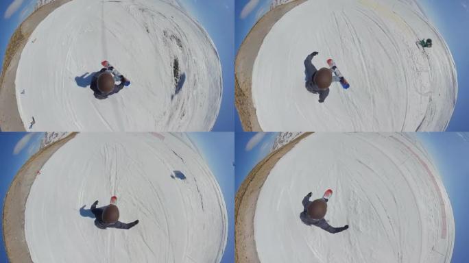 一个在滑雪场骑着滑雪板下山的人。360VR:从上面看