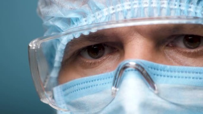 医生的脸，眼睛戴着安全眼镜。在Covid 19期间，肖像医学男性在医院或诊所佩戴保护和眼镜。健康员工
