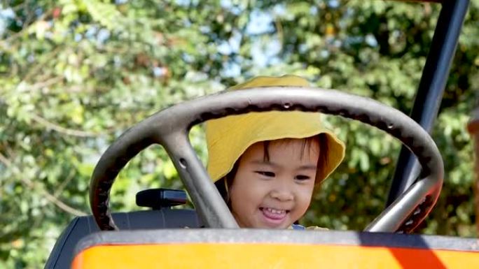 可爱的小女孩与拖拉机在最大的农业旅游专注于可持续发展在新加坡公园清莱，泰国。