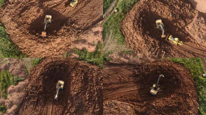 推土机的鸟瞰图正在刮擦一层土壤，挖掘机正在挖掘和倾倒污垢