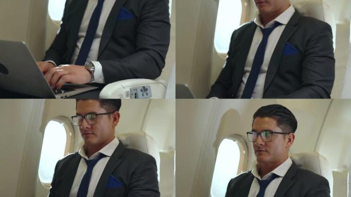 年轻的商人在飞机上使用笔记本电脑