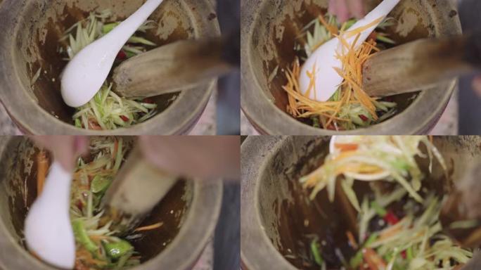 SLO MO: 制作Som Tam或辛辣的青木瓜沙拉，泰国东北部的名菜。