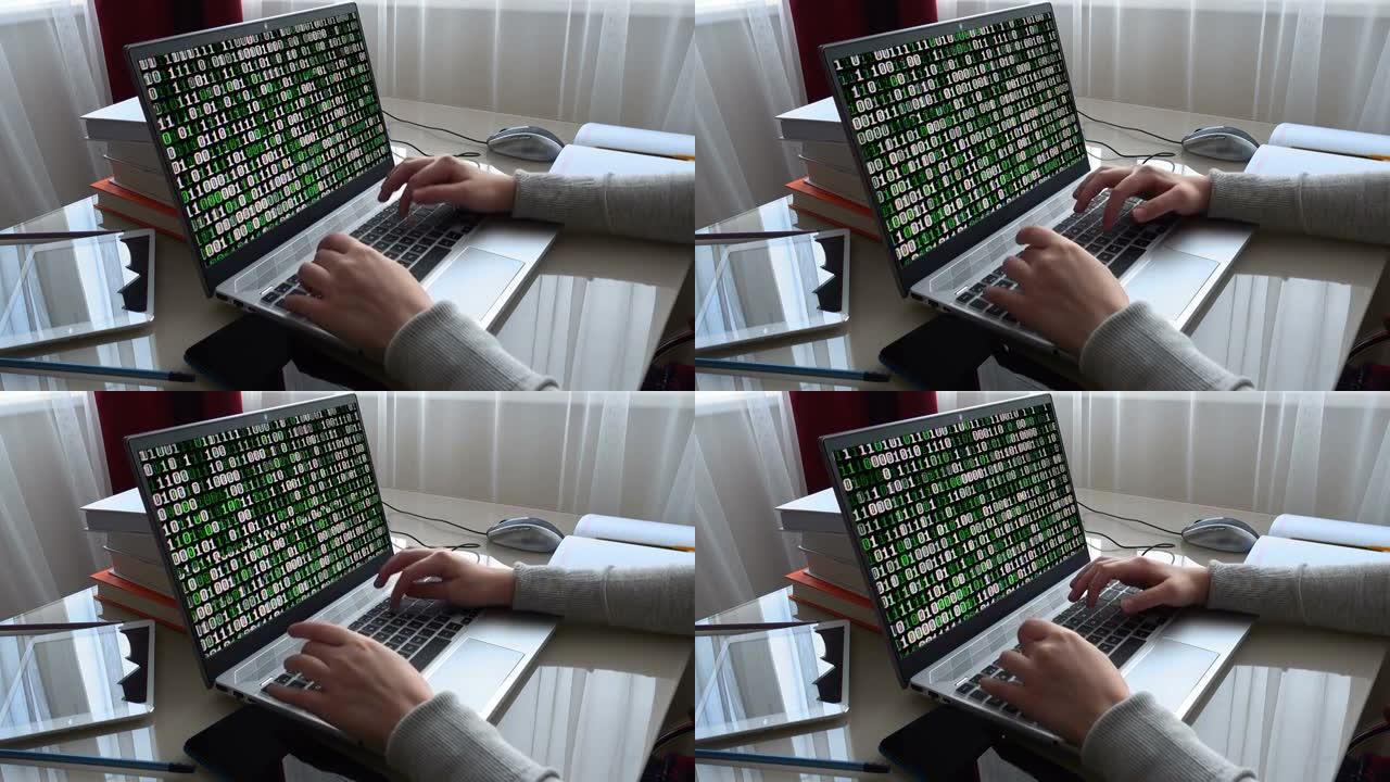 监视器屏幕上的二进制代码。在家庭办公室工作的女孩动手键盘。