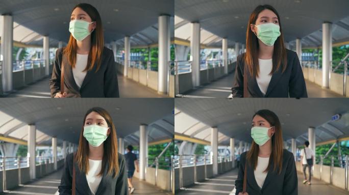 戴着防护口罩的亚洲女商人在冠状病毒大流行中上班