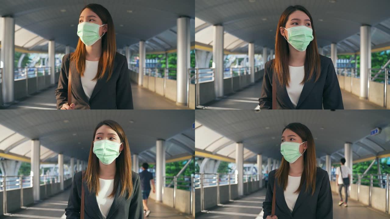 戴着防护口罩的亚洲女商人在冠状病毒大流行中上班