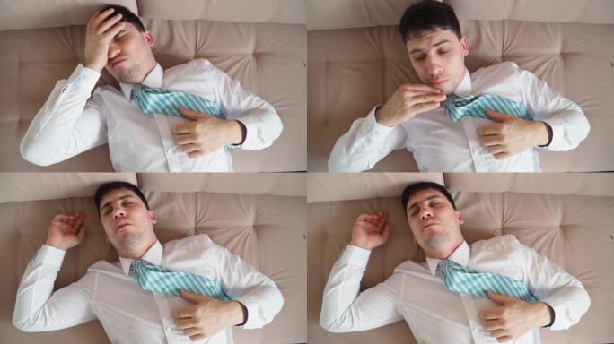 穿着白衬衫和领带沉睡的疲惫男人在办公室工作后睡觉