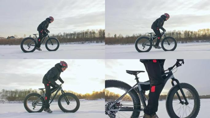 专业极限运动员骑自行车的人在户外骑胖自行车。骑自行车的人在冬天的冰雪上骑行。男人确实在戴着头盔和眼镜