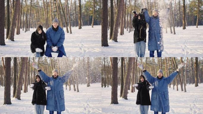 幸福的家庭在冬天的森林里玩得开心。一男一女正在扔雪。美妙的冬天阳光明媚的天气