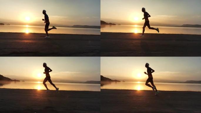 男子在日落时奔跑海边奔跑狂奔