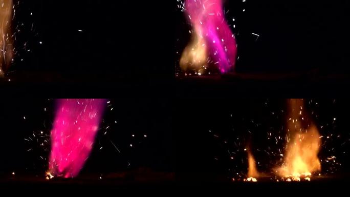 彩虹色的火，燃烧着的热篝火在黑暗的背景上火花。火火花动画，慢动作