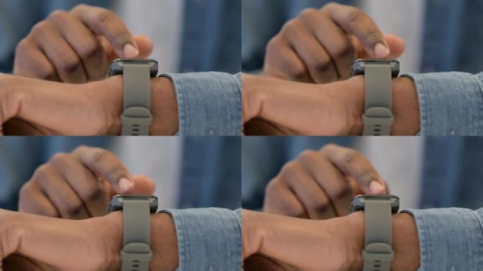 使用智能手表的非洲男性双手特写