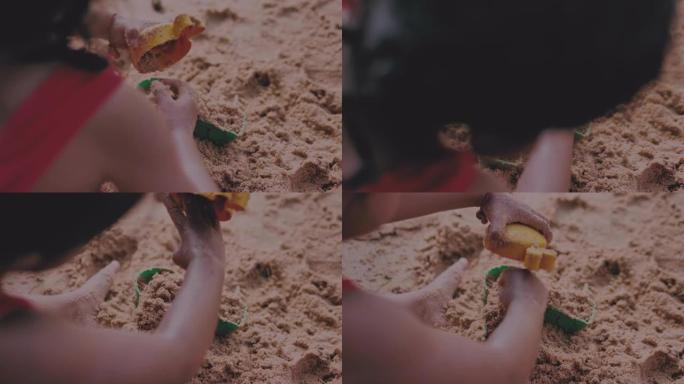 玩沙子和大海的小女孩