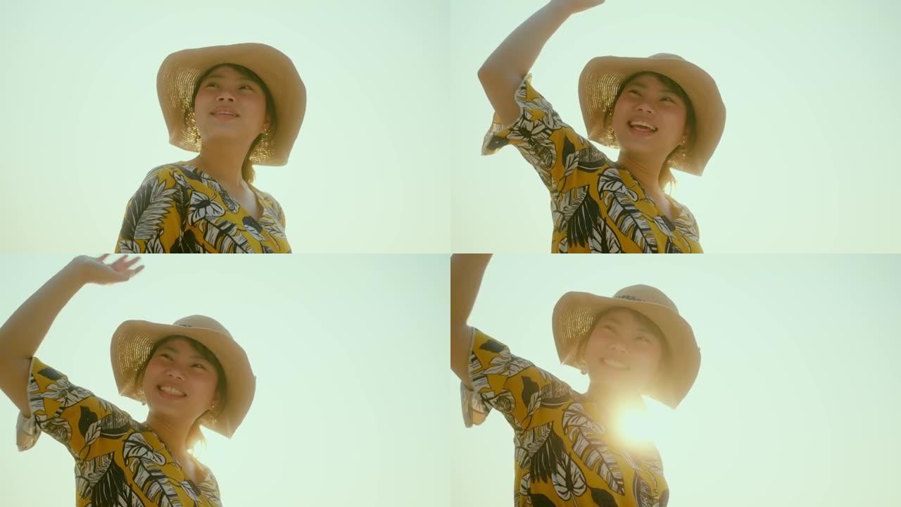 幸福蛤蜊亚洲女性旅行者休闲布带帽子散步享受沙滩日落moent沙滩海洋背景旅游旅游概念