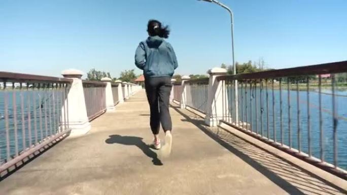在桥上慢跑的运动女人