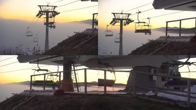 日落时分，升降椅在清澈的山顶上移动，从薄雾中升级。乌克兰喀尔巴阡山脉布科维尔滑雪胜地的雾天