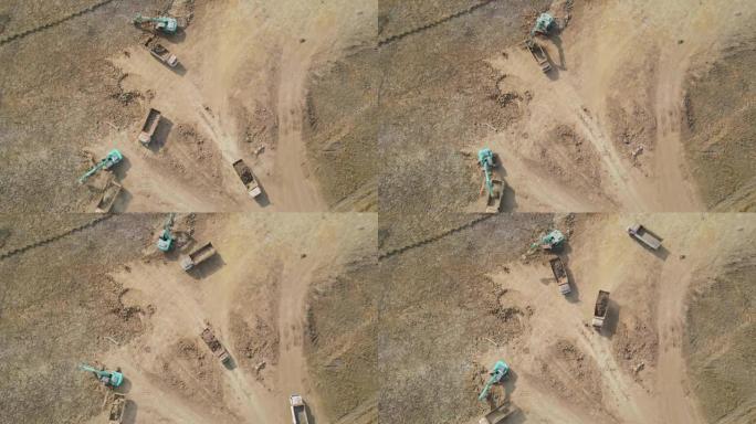 在施工现场工作的卡车和挖掘机的鸟瞰图