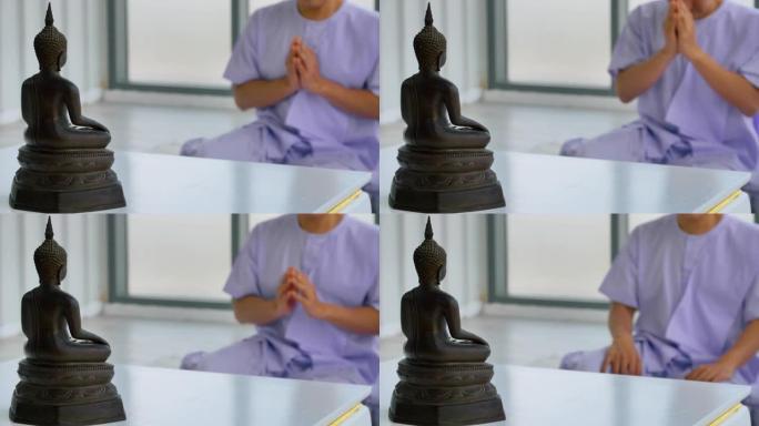 亚洲佛教徒向佛陀祈祷。