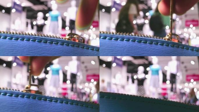 销售和购物概念。一个特写包和一个时尚精品店的访客在背景。高清视频。