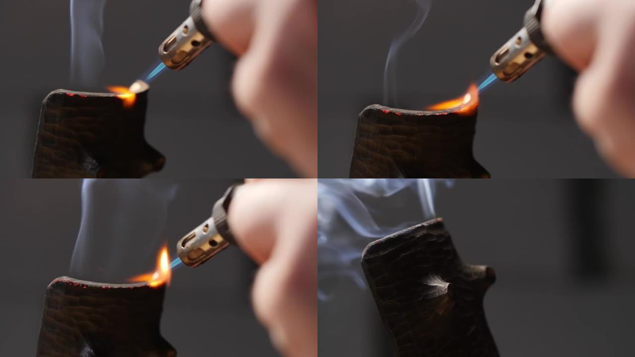 木匠用燃烧器烧掉一个木制茶架。木工艺术。手工制作的概念