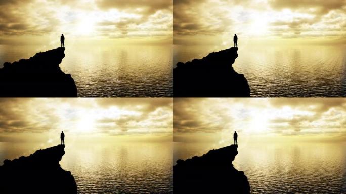 一个站在悬崖边缘的男人的剪影吸收了太阳的治愈能量，同时目睹了大自然的壮丽景色
