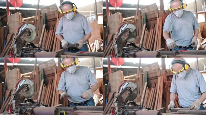 在木匠工场工作的亚洲老木匠。