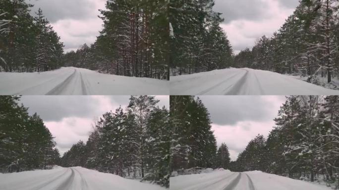 在森林里积雪覆盖的湿滑道路上谨慎驾驶。冬天在空旷的道路上行驶的汽车。