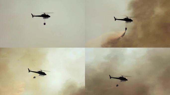 剪影消防直升机在森林大火中滴水