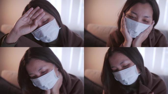 患有冠状病毒的年轻亚洲女性全身黑眼睛发冷，她用口罩和毯子在单独的客厅和检疫的沙发上保暖